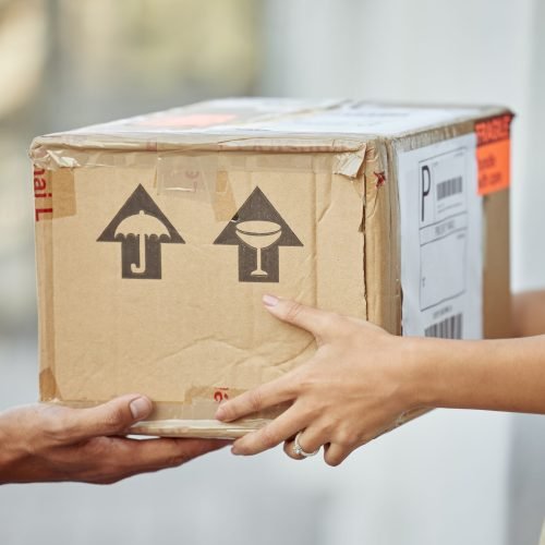 Finally my parcel has arrived. Shot of a delivery man passing a package to a customer